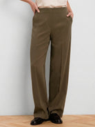Olive wide-leg pants with a smooth finish, high waist, flat front, and side pockets.