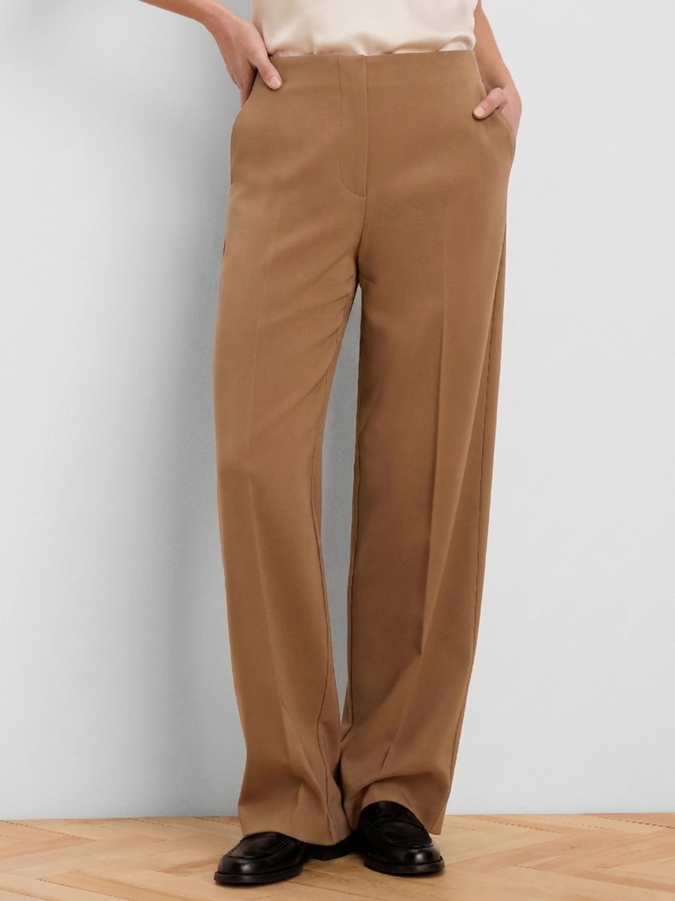 Camel wide-leg pants with a high, flat waist, side pockets, and a center leg crease.