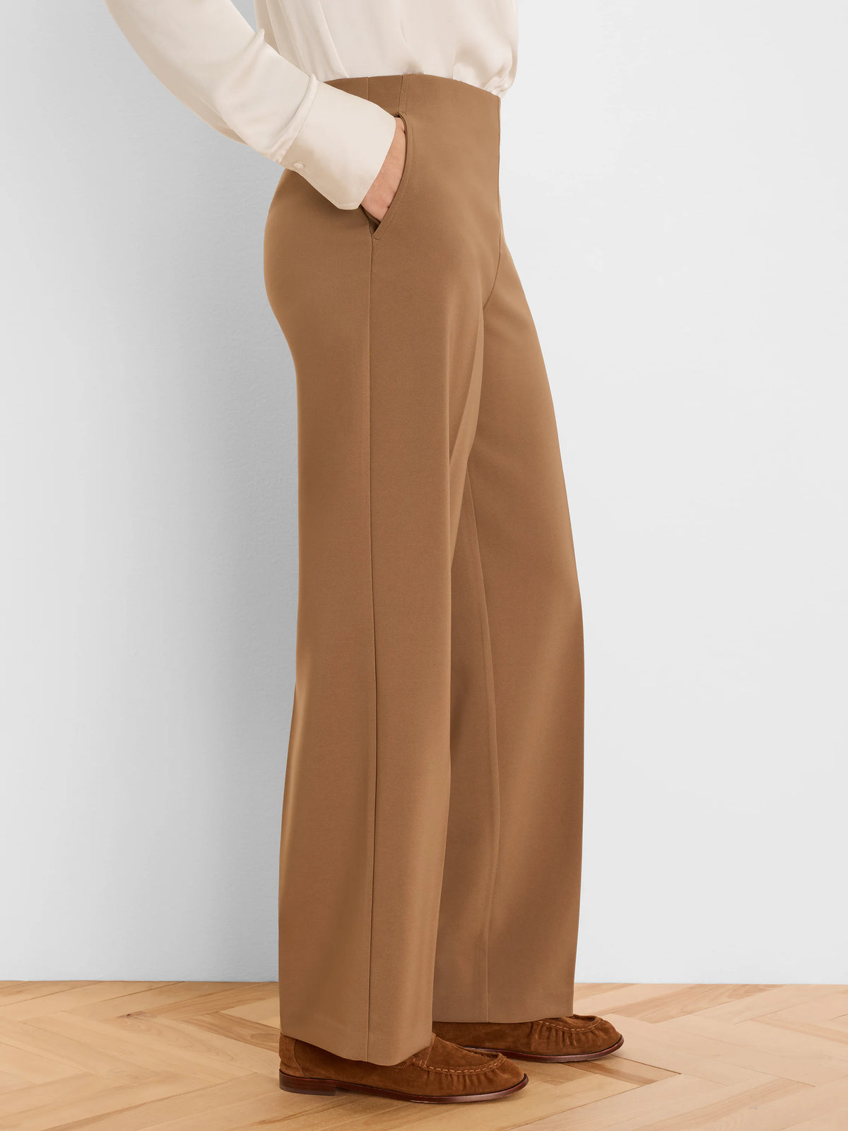 High-waisted, wide-leg camel brown pants with side pockets. Appears sleek and smooth.