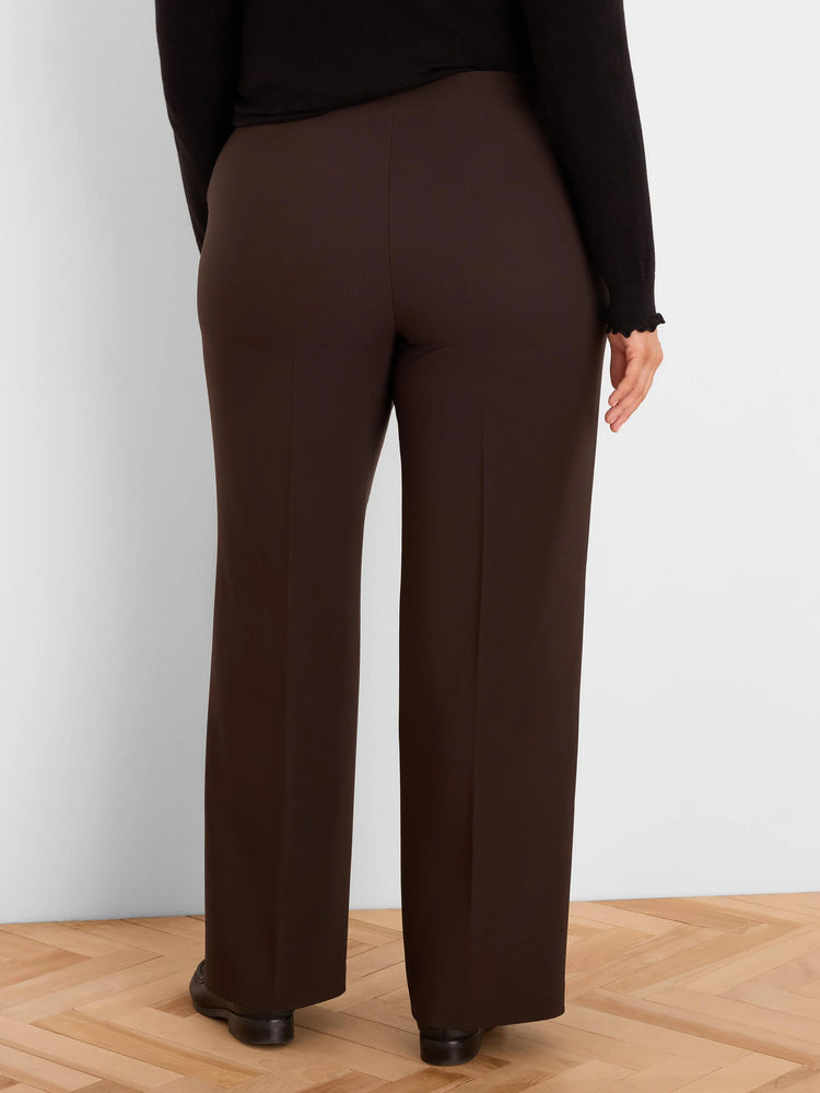 Deep brown wide-leg pants with sharp vertical leg creases, shown on a model from behind.