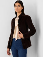 Dark brown velvet jacket with a stand collar, teal buttons, and a fitted silhouette.