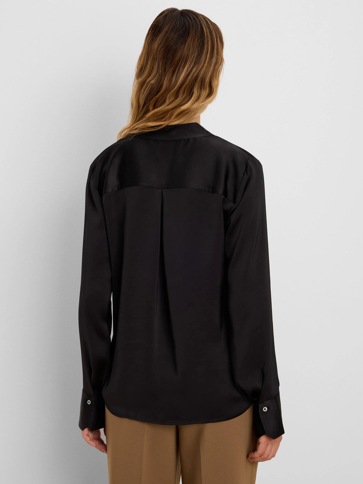 Black glossy long-sleeve shirt, shown from the back, with button cuffs, a back yoke, and a center pleat.