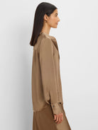 Glossy brown long-sleeved shirt with an open V-neck collar and buttoned cuffs.