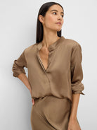 Glossy mocha brown shirt with a band collar, open V-neck, and rolled-up long sleeves.