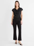 Black short-sleeve drape neck tee with a subtle gloss finish, worn by a model.