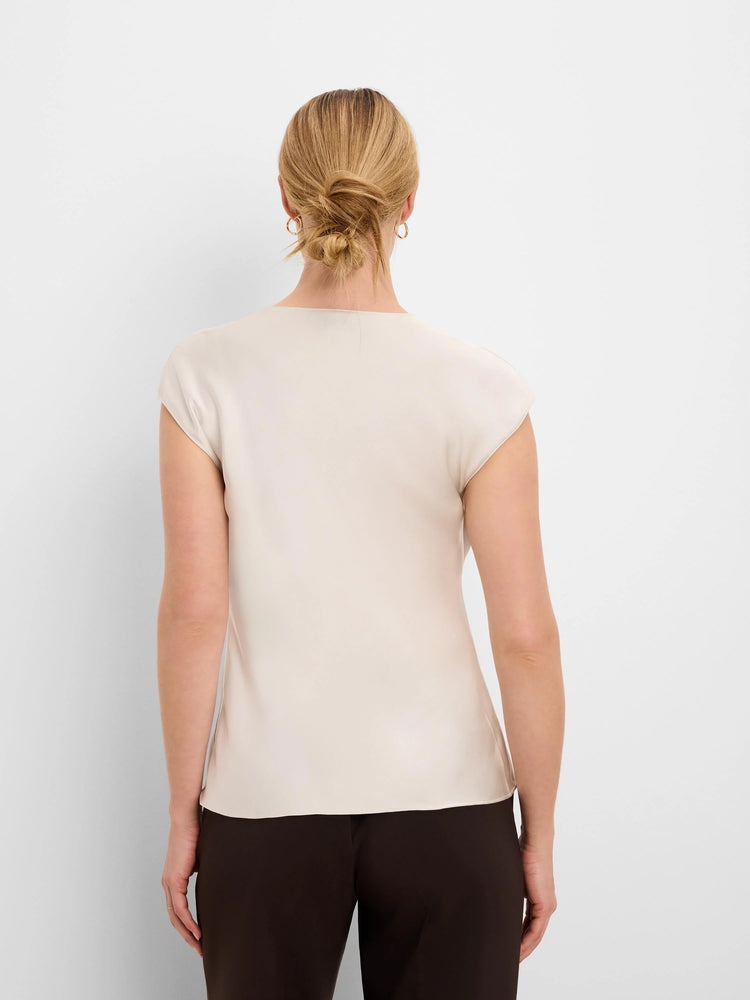 Back view of a pale beige glossy tee with cap sleeves and a smooth, high neckline.