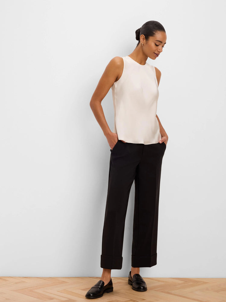 Ivory sleeveless tank with a subtle gloss finish, round neck, and relaxed fit.