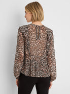 Sheer black, beige, and peach animal print shirt with ruffled shoulders, long gathered sleeves, and keyhole back.