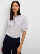 Light blue shirt with white and thin brown vertical stripes, a band collar, and short puff sleeves.