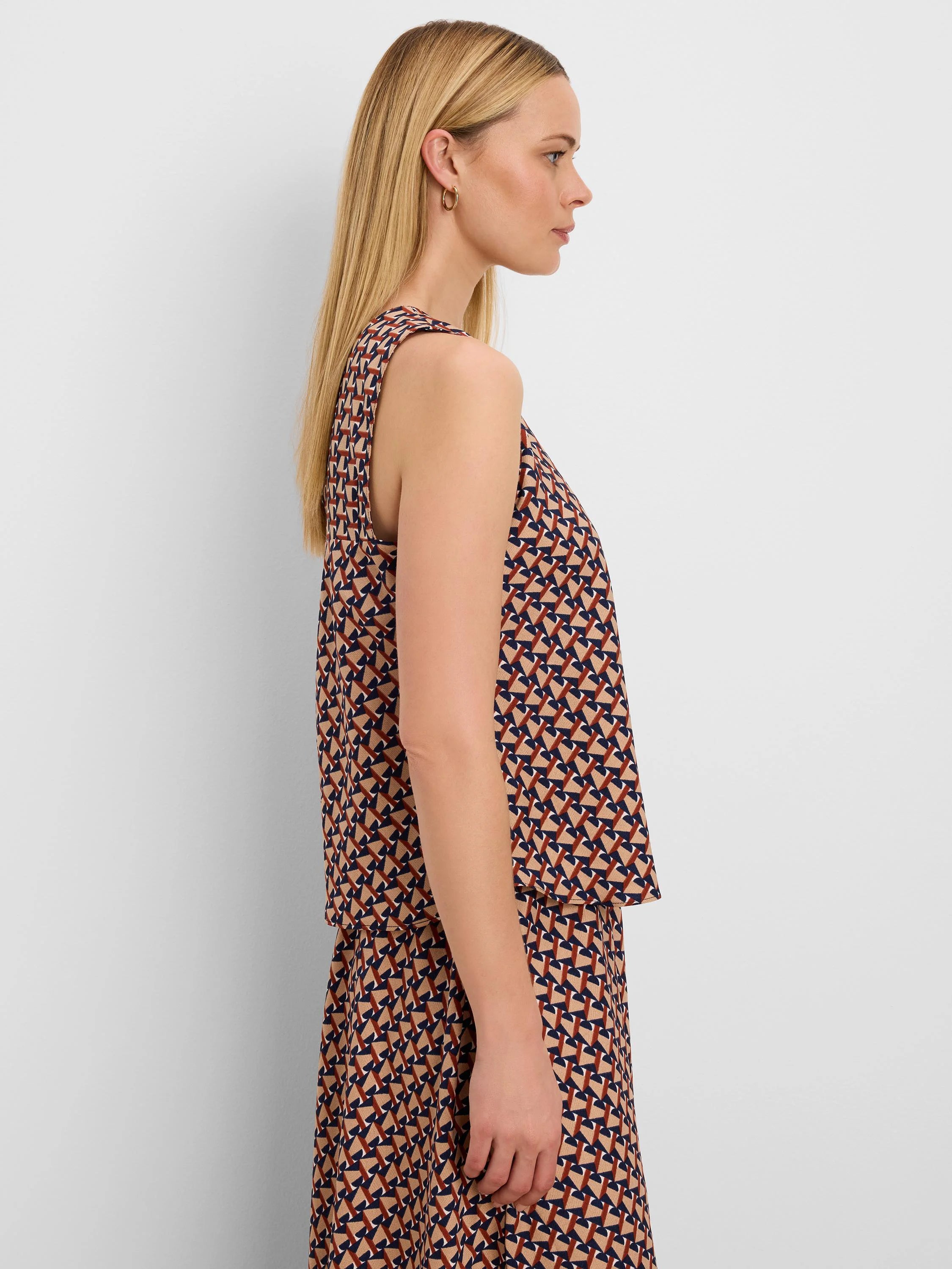 Tan, navy, and rust sleeveless top with a geometric tile pattern.