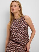 Sleeveless round neck top with a geometric tile pattern in beige, navy, and reddish-brown.
