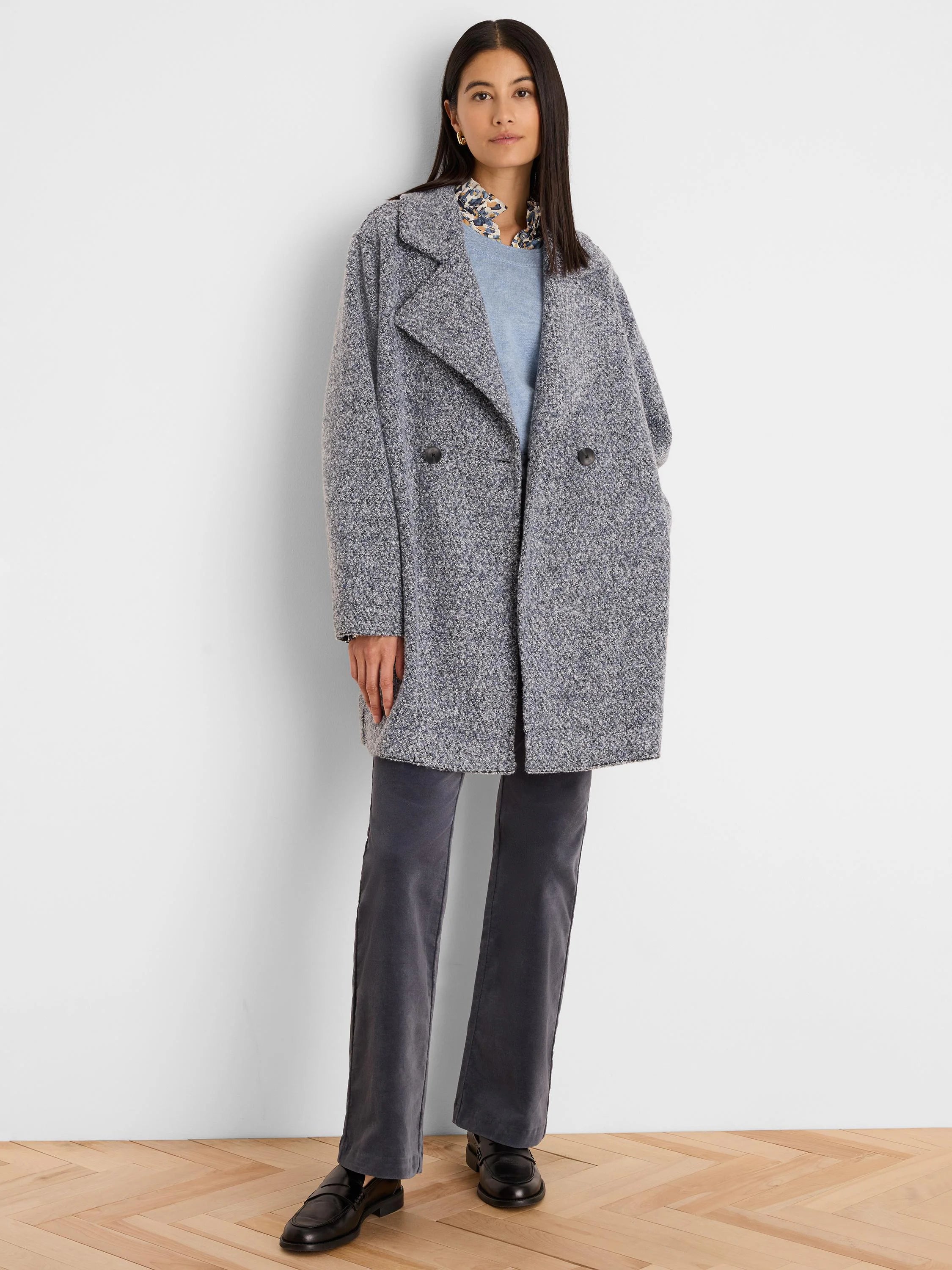 Patterned shirt with a ruffled collar, featuring abstract blue, brown, cream, and black flake shapes.