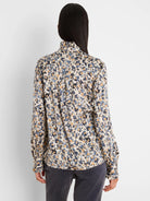 Cream shirt with abstract blue and gold flake pattern, featuring a ruffled collar and cuffs. Back view.