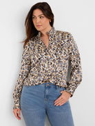 Cream shirt with abstract blue, gold, and black 'flake' pattern. Features a ruffled stand collar, V-neck, and ruffled cuffs.