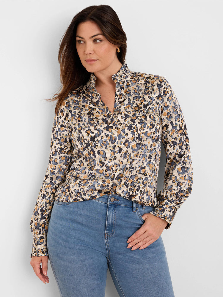 Cream shirt with abstract blue, gold, and black 'flake' pattern. Features a ruffled stand collar, V-neck, and ruffled cuffs.