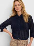 Dark blue sheer chiffon jacquard shirt features a crinkled grid texture, button-front, and collar.