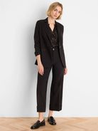 Black Lurex shirt with shimmering gold diamond-like pattern. V-neck, long sleeves.