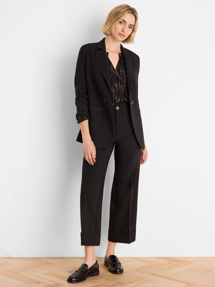Black Lurex shirt with shimmering gold diamond-like pattern. V-neck, long sleeves.