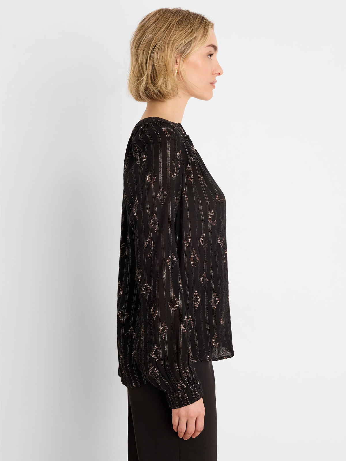 Black long-sleeve shirt with rose gold metallic diamond and vertical stripe patterns.