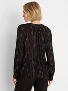 Black lurex shirt with thin metallic vertical stripes and scattered brown diamond shapes. Loose fit, long sleeves.