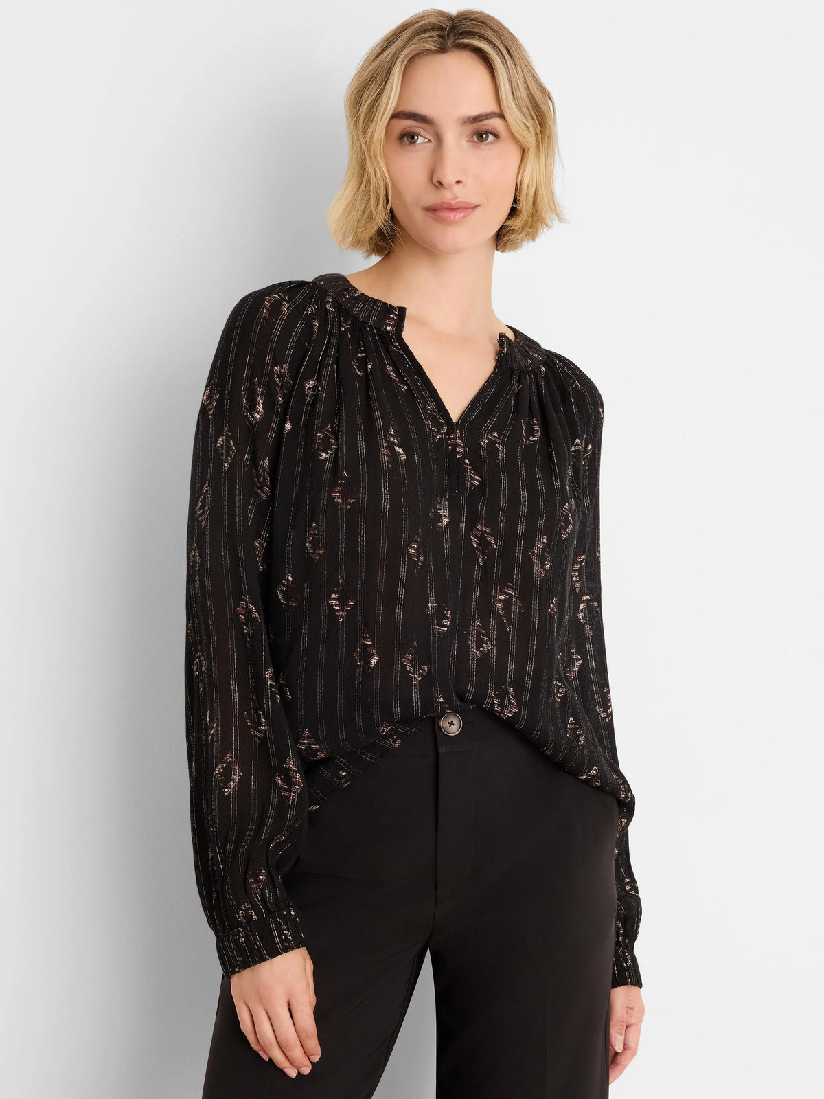 Black Lurex shirt with golden metallic diamond and stripe pattern. V-neck, long sleeves with elastic cuffs.