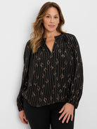 Black Lurex shirt with thin silver vertical stripes and scattered rose gold metallic diamond patterns. V-neck, long sleeves.