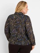 Dark crinkled chiffon shirt with blue, beige, & olive paisley pattern. Long sleeves, high collar. Model's back shown.