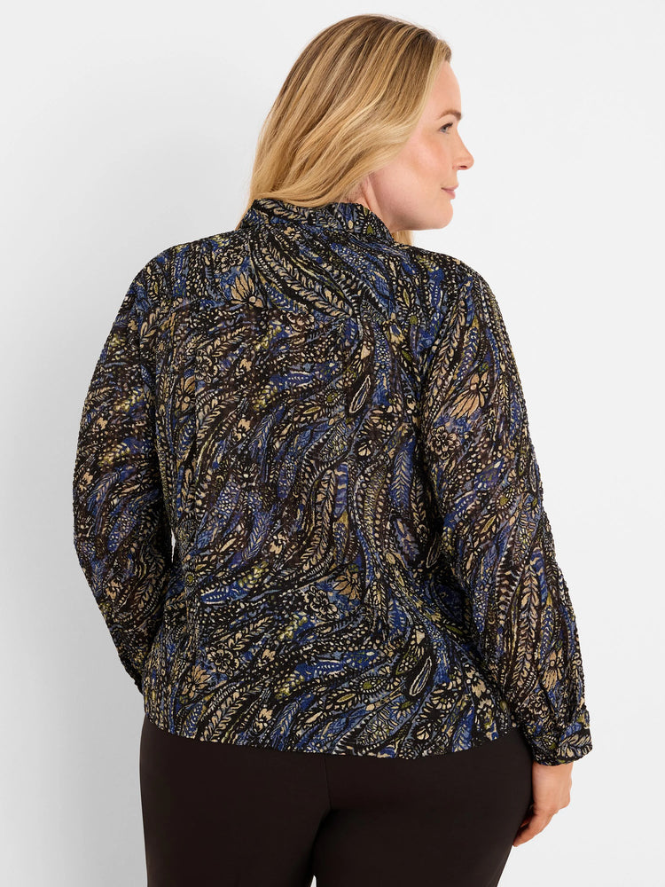 Dark crinkled chiffon shirt with blue, beige, & olive paisley pattern. Long sleeves, high collar. Model's back shown.