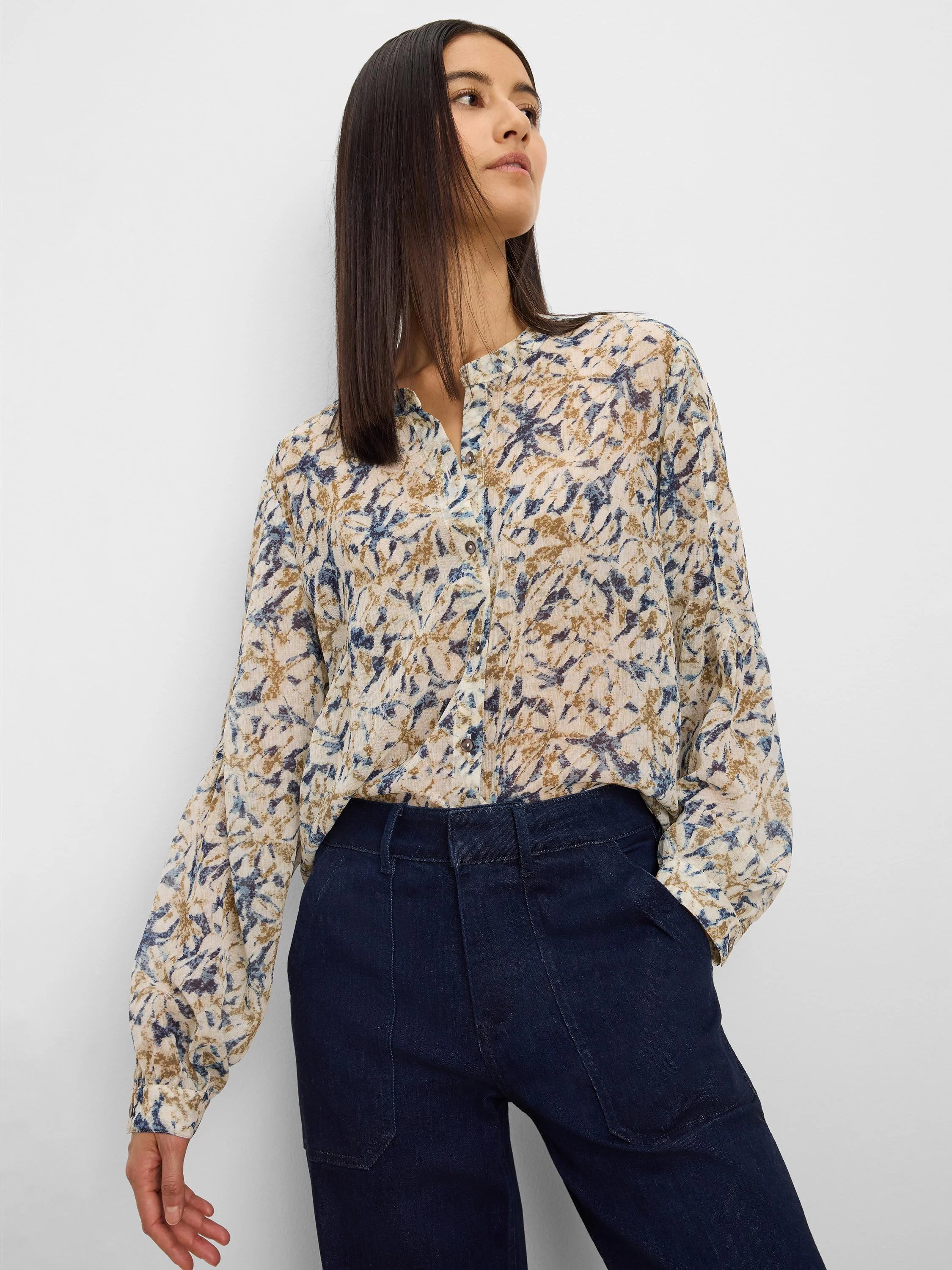 Cream chiffon shirt with abstract blue and brown pattern, band collar, long cuffed sleeves.