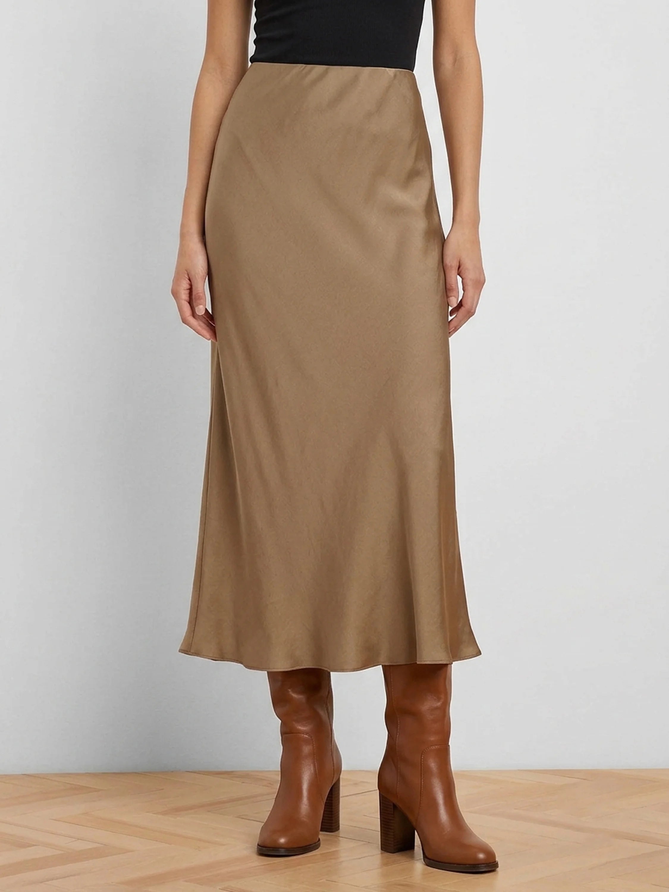 Tan glossy midi slip skirt, softly draped.