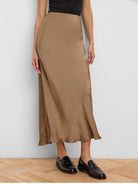 Camel gloss slip skirt, midi-length, with a flowing drape.