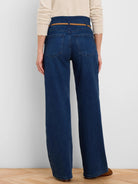 Dark blue wide-leg jeans with a thin brown belt, viewed from behind. Features high waist and back pockets.
