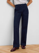 Dark blue, high-waisted, wide leg jeans with front patch pockets.