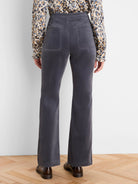 Charcoal grey velvet high-rise bootcut pants with two back patch pockets.