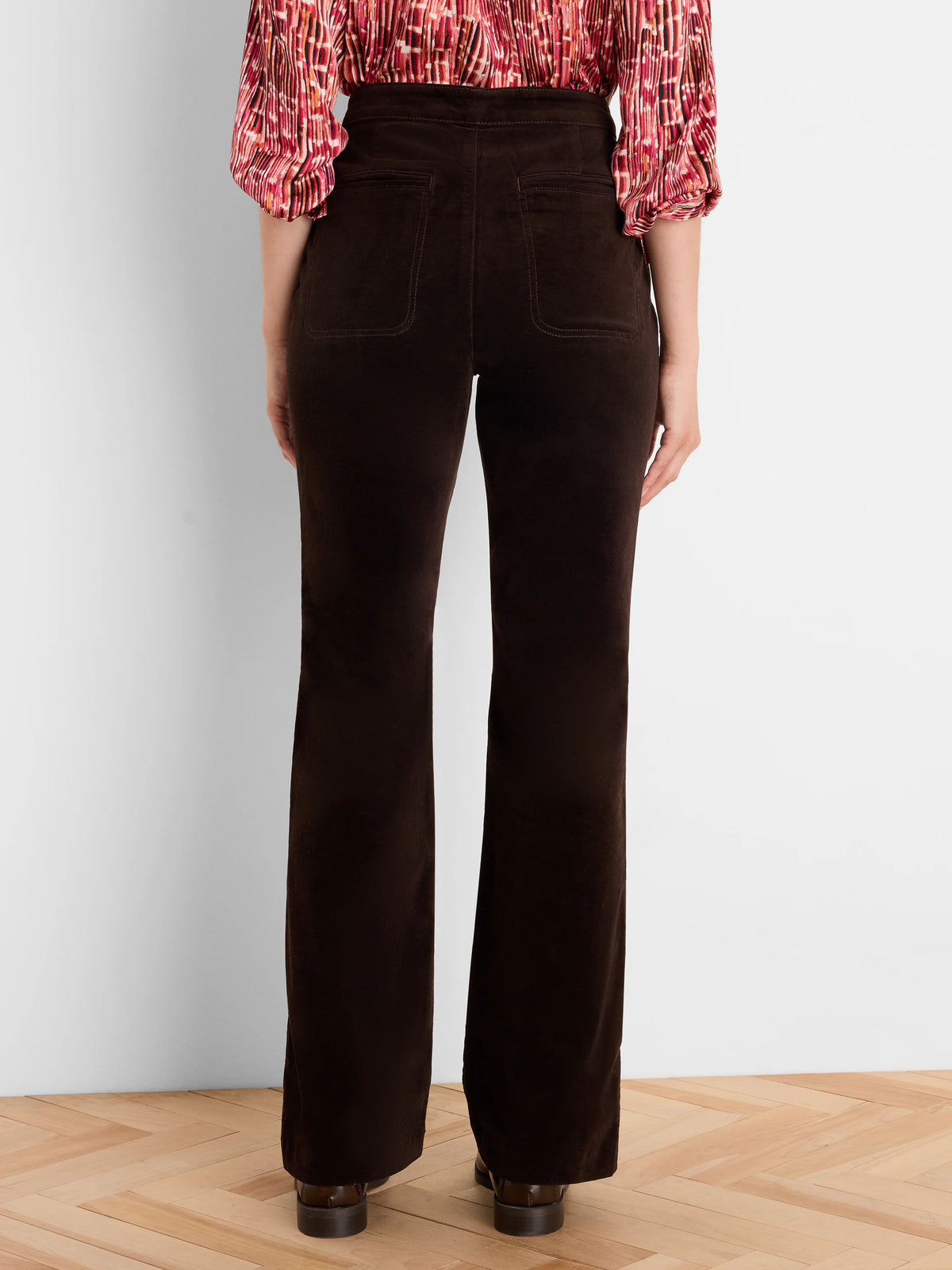 Dark brown velvet high-rise boot-cut pants, back view with two pockets.
