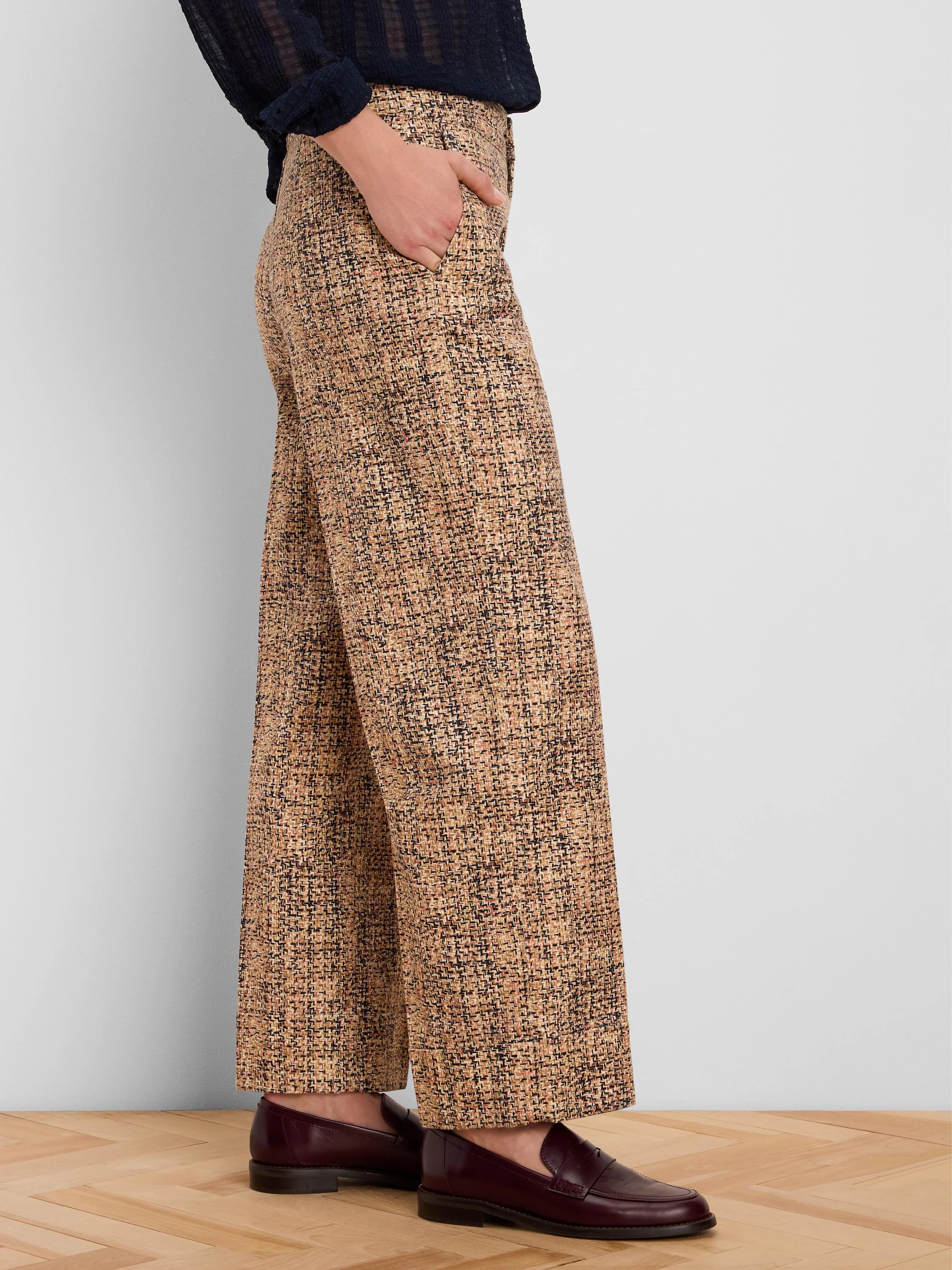 Light brown tweed wide-leg ankle pants with cuffs. Fabric shows black and subtle reddish flecks in the pattern.