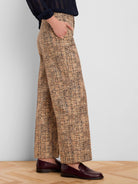 Light brown tweed wide-leg ankle pants with cuffs. Fabric shows black and subtle reddish flecks in the pattern.