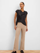 Tan, full-length, boot-cut Wonderstretch pants on a model.