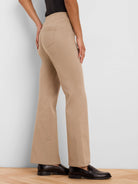 Tan high-waisted bootcut pants with back pockets, shown from behind on a model.
