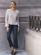 Dark indigo bootcut jeans, fitted through the thigh, with a subtle flare at the ankle.