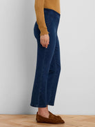 Dark blue boot-cut jeans with a high waist and diagonal seam details on the front.