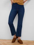 Dark blue ankle-length bootcut jeans with a smooth flat front.