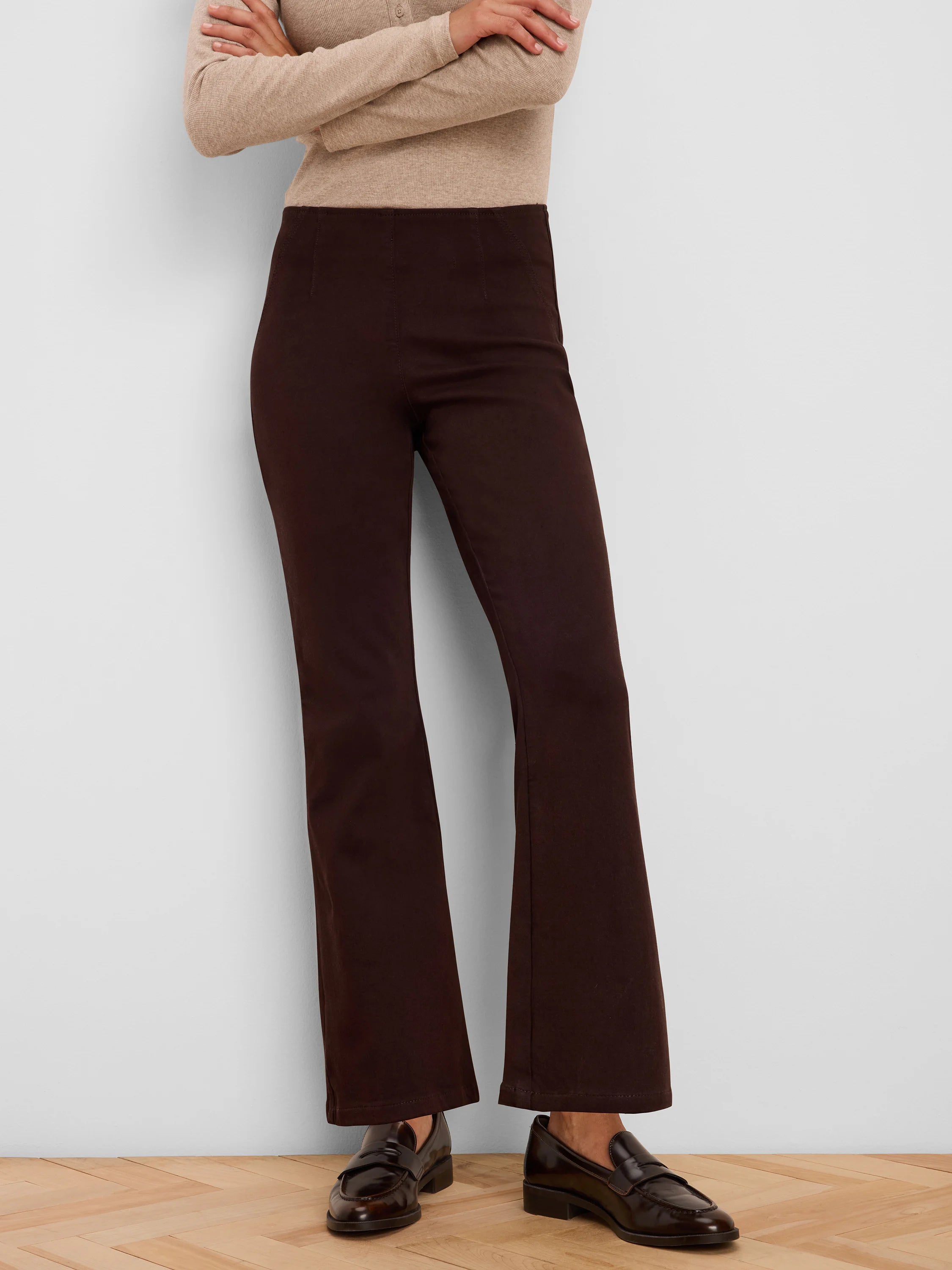 Dark brown jeans with a smooth, flat waist and subtle bootcut flare.