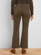 Dark olive green bootcut jeans, high-waisted, with two rear patch pockets. Seen from behind.