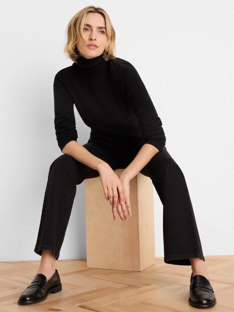 Dark black, relaxed boot-cut jeans, subtly flared at the ankle.