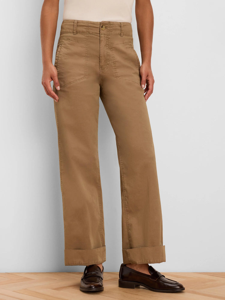 Tan wide-leg pants feature a high waist, angled front pockets, and cuffed hems.