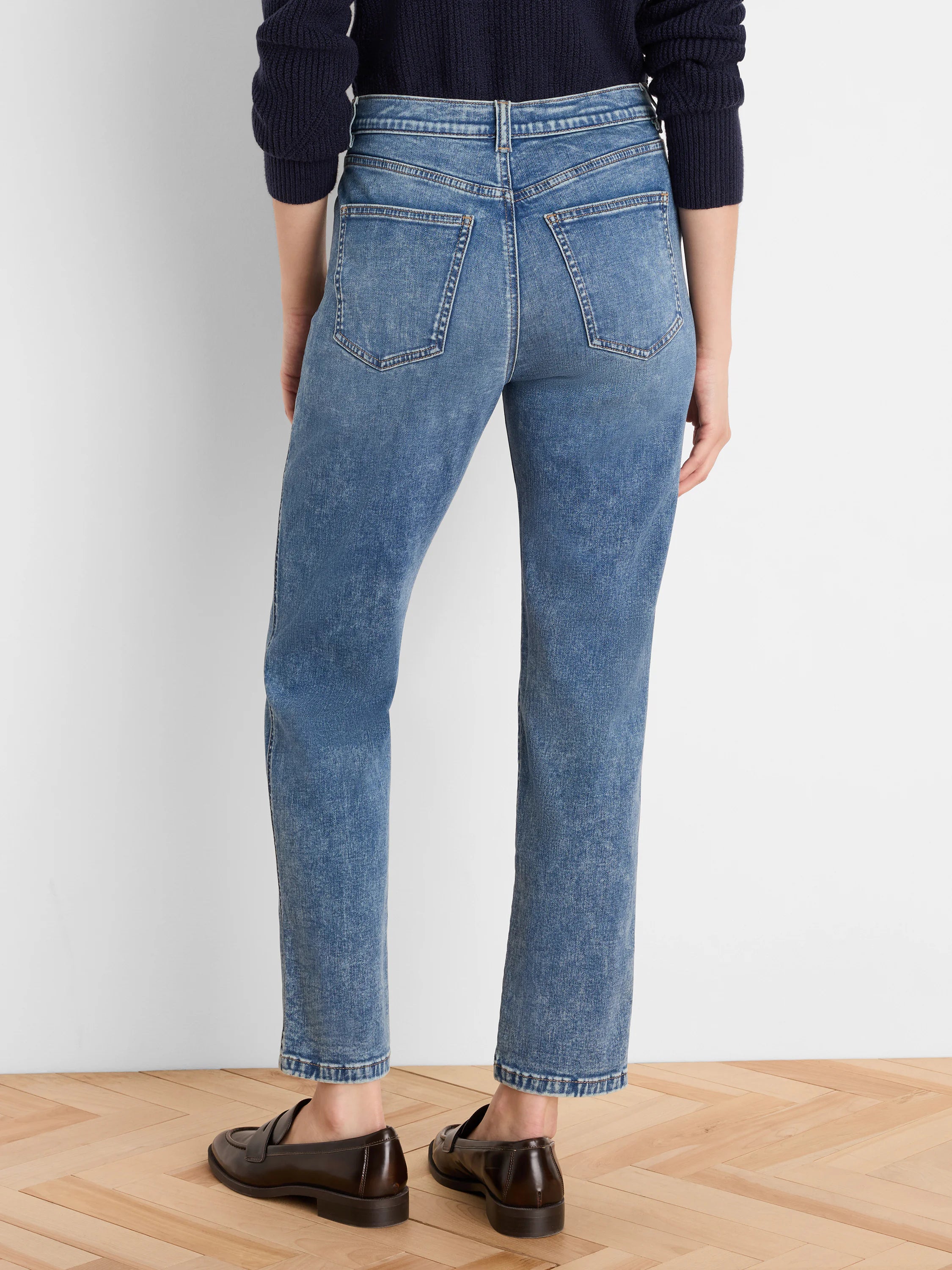 Medium blue, vintage wash straight leg jeans shown from the back, featuring classic back pockets and an ankle-length hem.