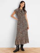Leo Georgette Dress: Black/pink abstract print, tie-neck, flutter sleeves, elastic waist, pleated maxi skirt.