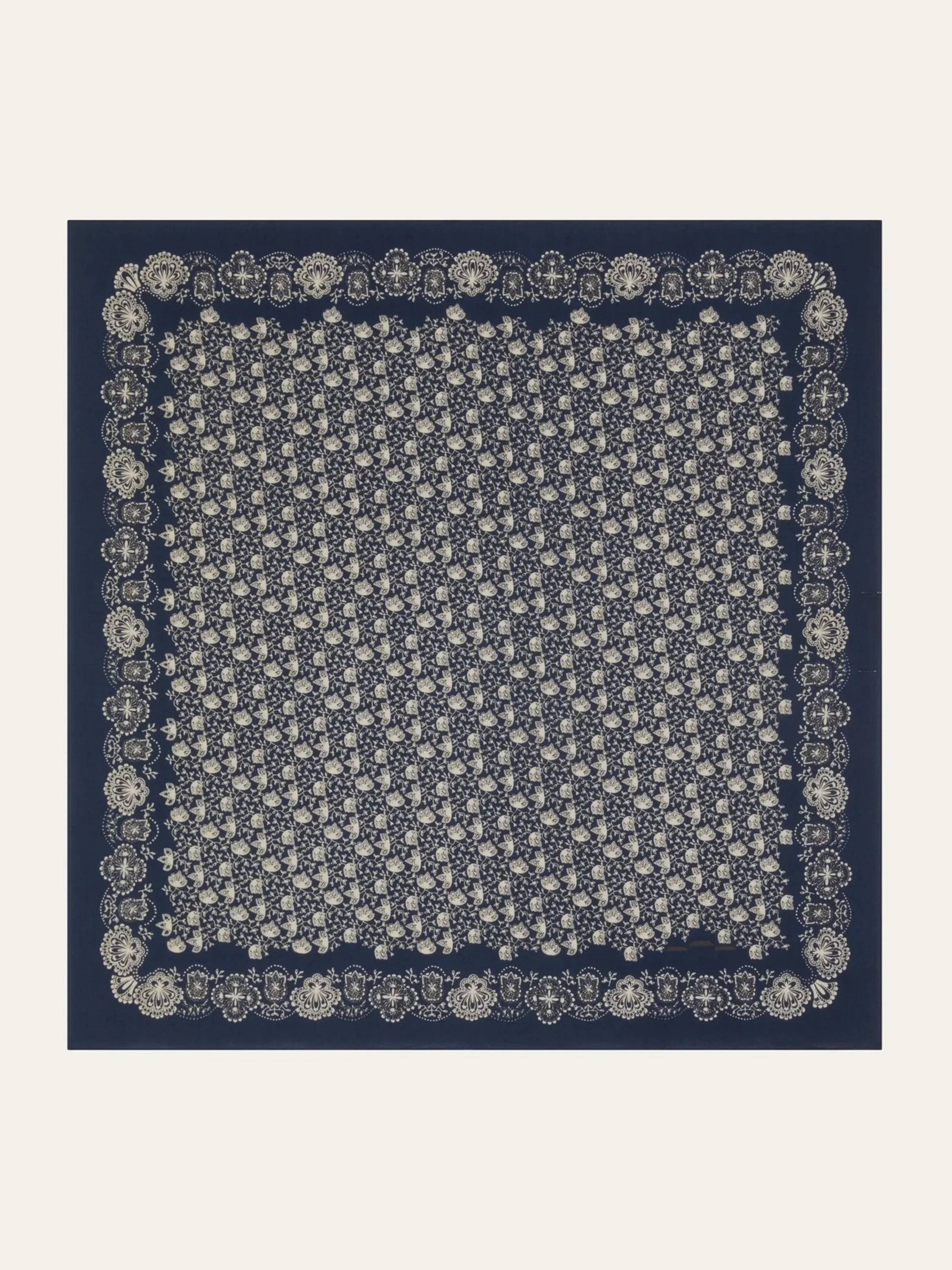 Navy blue scarf with an off-white floral pattern and border.