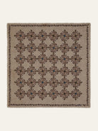 Beige square scarf with brown and blue floral pattern; dark brown and green border.